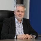 Man in a suit sat at a desk