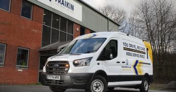 Fraikin-branded van parked outside of a Fraikin-branded building