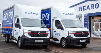 Two Rearo branded vans, parked outside a Rearo shop.