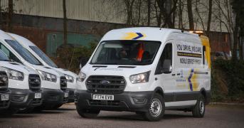 White liveried transit van, parked in a car park with three other similarly liveried vans