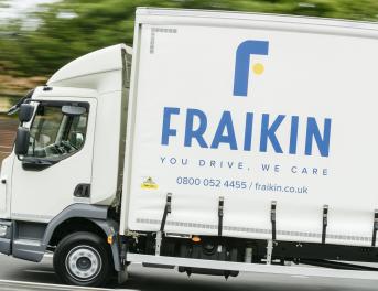 A Fraikin delivery truck in motion on a road, with the company's logo and slogan "You Drive, We Care" visible on the side.
