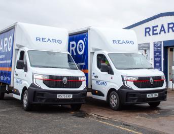 Two Rearo branded vans, parked outside a Rearo shop.