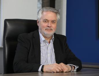 Man in a suit sat at a desk
