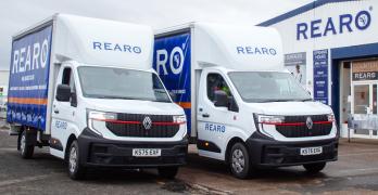Two Rearo branded vans, parked outside a Rearo shop.