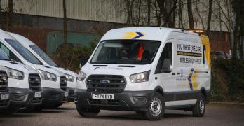White liveried transit van, parked in a car park with three other similarly liveried vans
